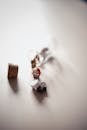 Scattered Figurines Next to Glass Bottle