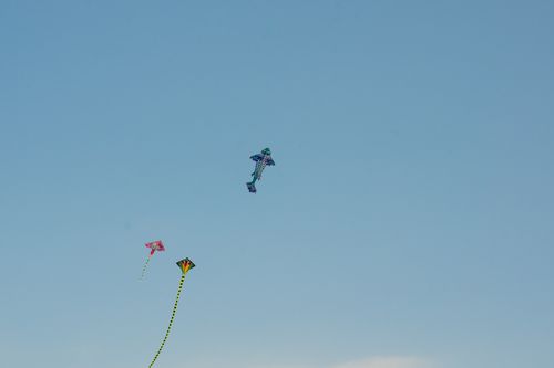 Free Vibrant kites flying high in a clear blue sky, evoking a sense of freedom and playfulness. Stock Photo