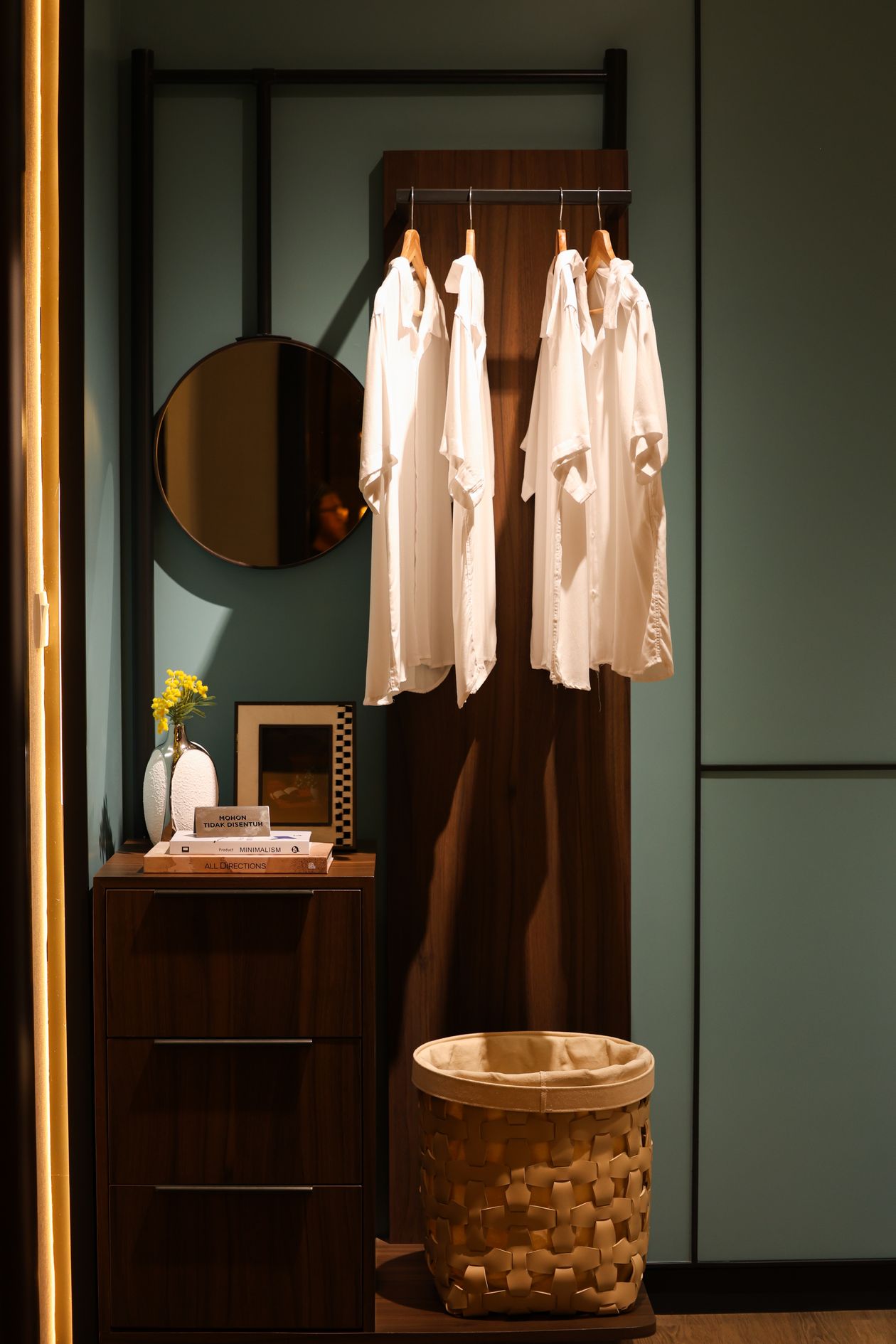 Slim wardrobe with hanging organisers in a small bedroom.