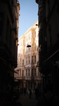 Captivating view of a historic building facade in an İstanbul alleyway, basking in afternoon light.