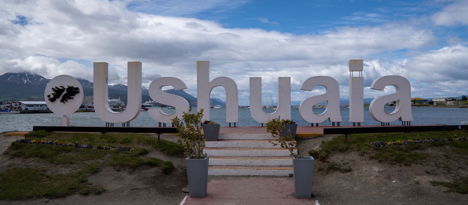 Iconic Ushuaia sign in Argentina with stunning mountain and sea view. — flights from Buenos Aires to Ushuaia