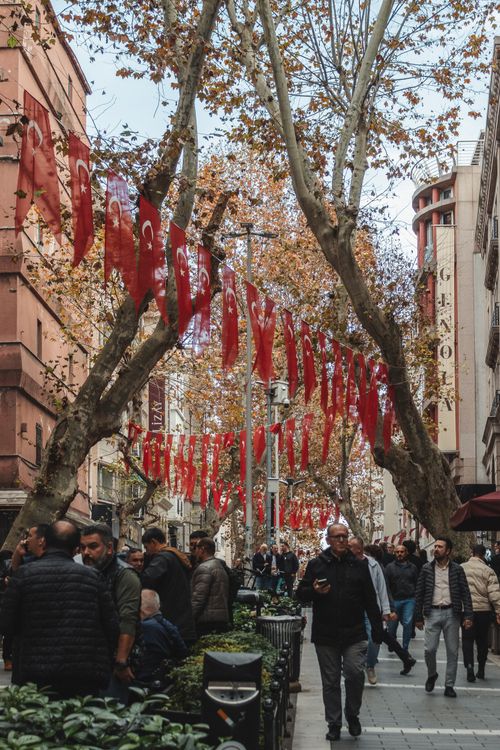 Free Lively street with people and Turkish flags during fall season in an urban area. Stock Photo