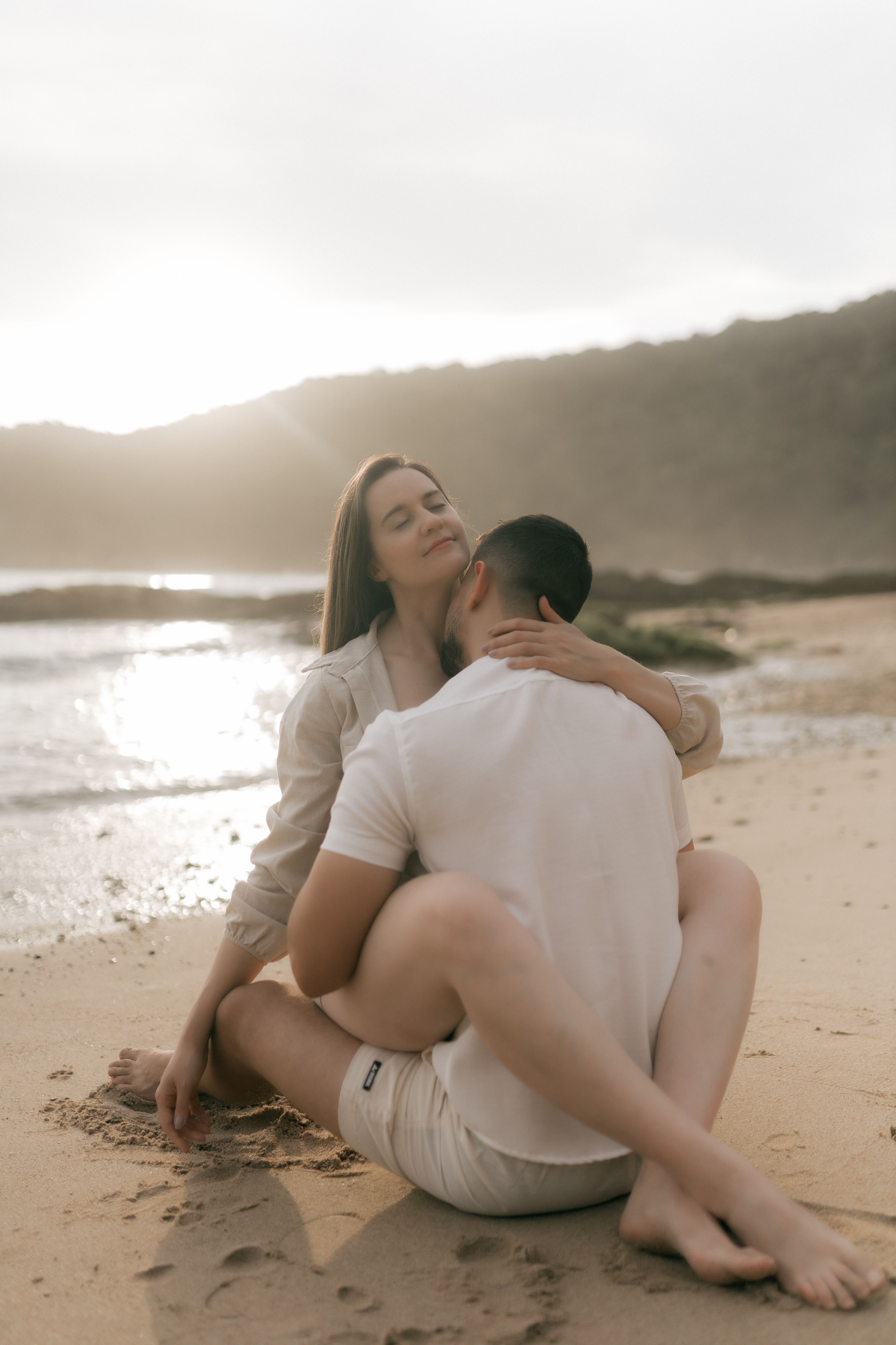 Romantic Beach Couple Embracing at Sunset · Free Stock Photo