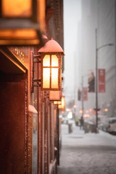 Cinematic view of an antique lamp on a snowy Chicago street during a winter storm.