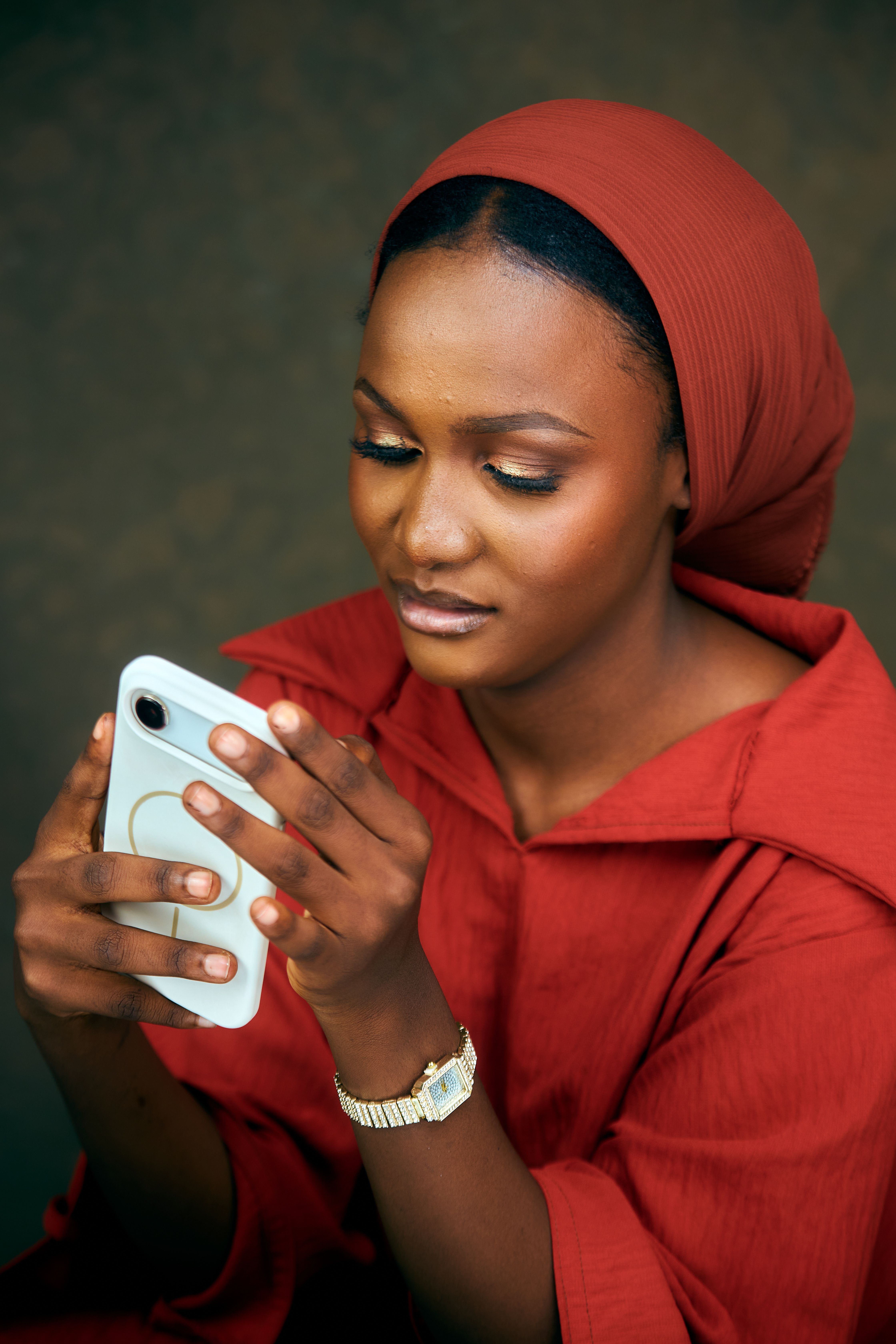 Elegant Woman in Red Hijab Using Smartphone · Free Stock Photo