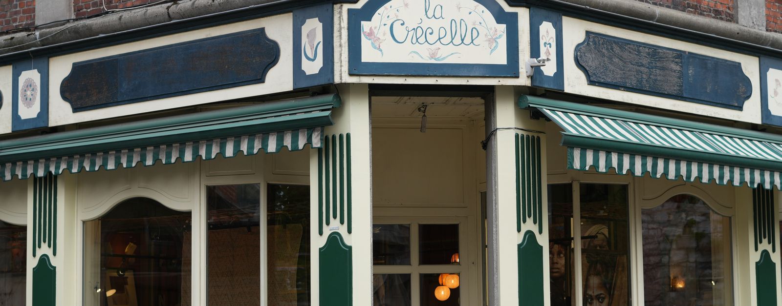 Historic storefront of 'La Crécelle' in Dinant, Belgium.