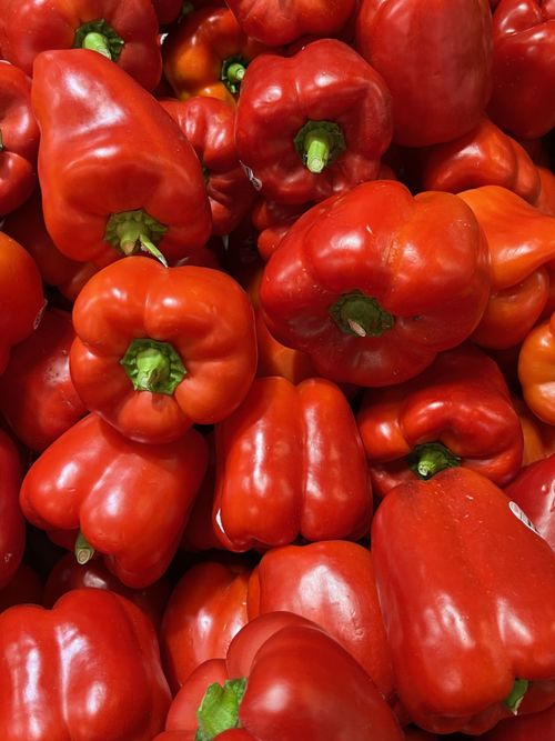 Free Vibrant red bell peppers stacked in abundance, showcasing organic freshness. Stock Photo