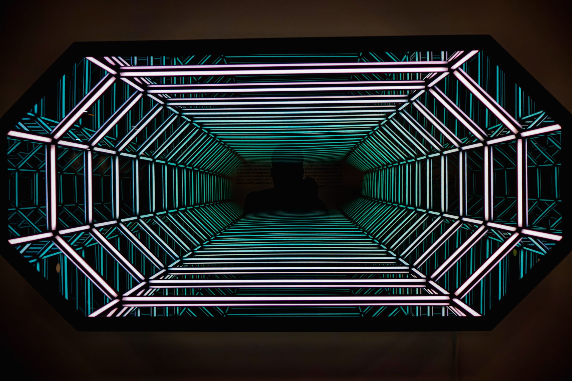 An abstract view inside a neon-lit tunnel creating a futuristic effect with vibrant colors.