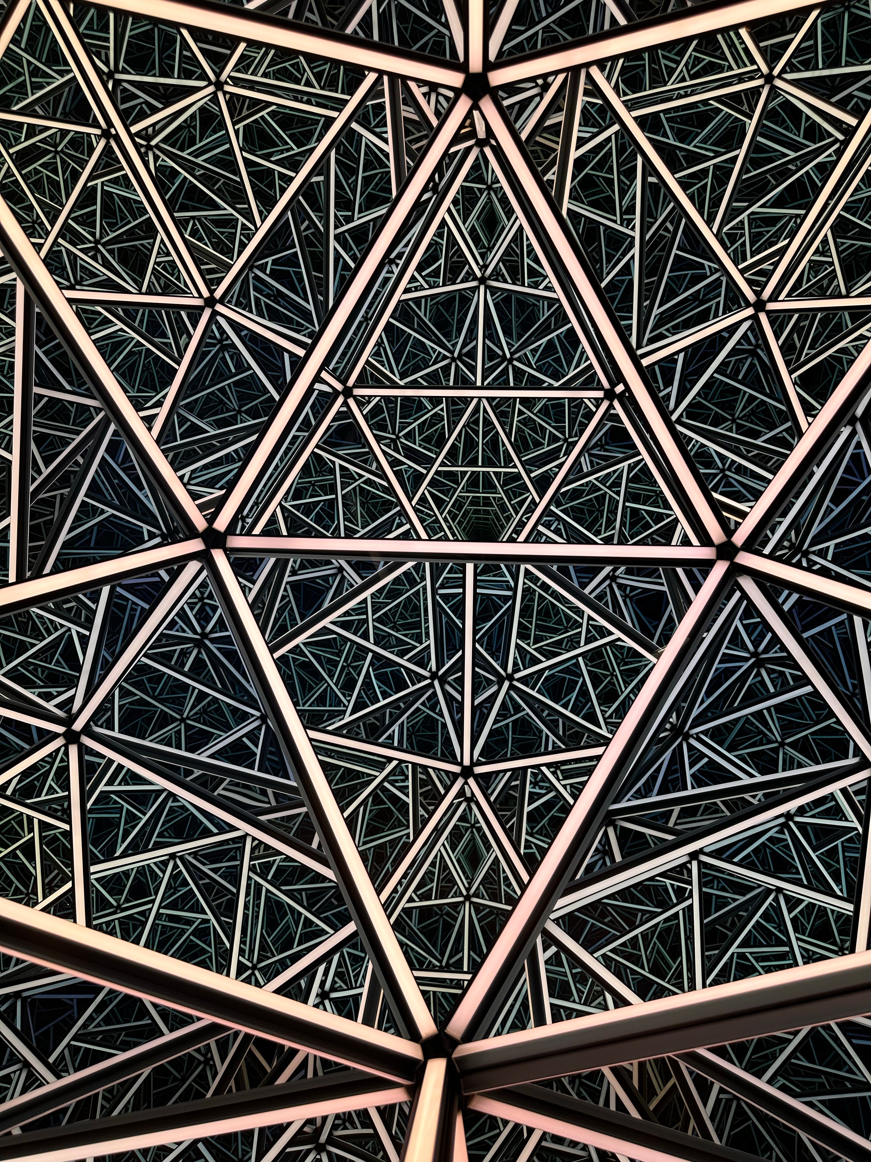 Intricate geometric pattern forming a modern architectural design, emphasizing symmetry.