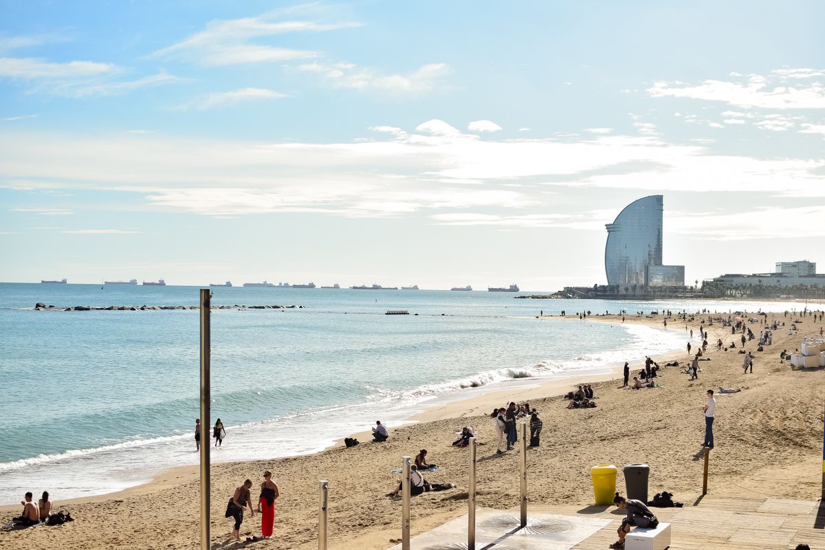 Sunset views of golden sand and the Mediterranean coast at Barceloneta Beach