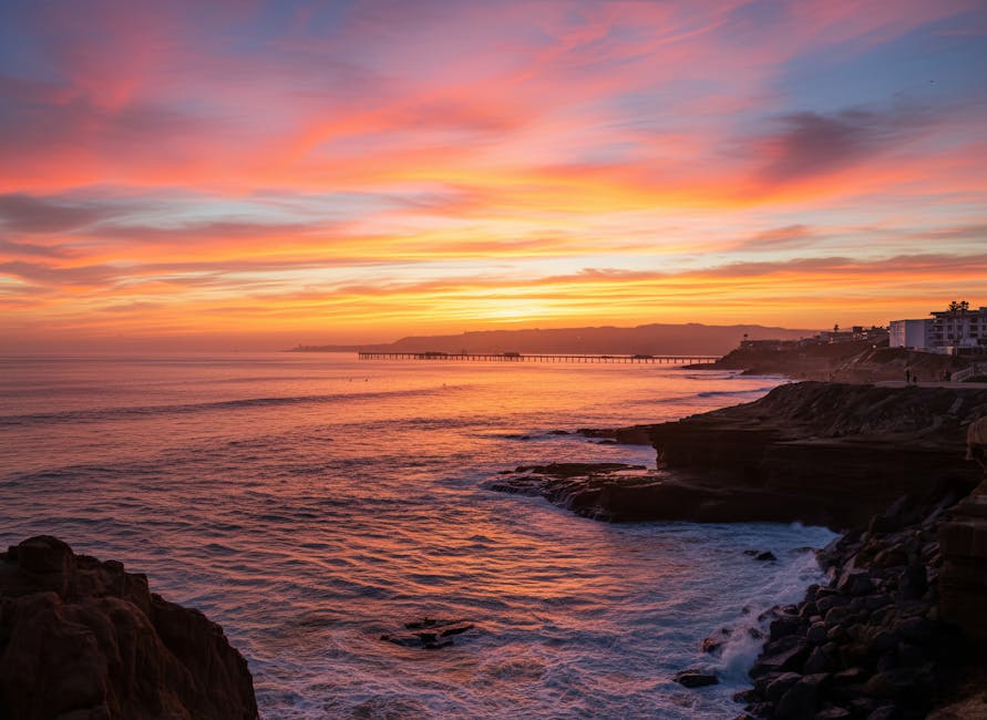 Dramatic sunset view of San Diego coastline with cliffs and pier, perfect for coastal wall art.