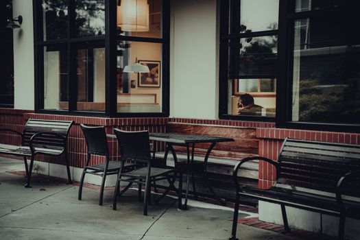 Charming outdoor cafe seating with a glimpse of interior ambiance.