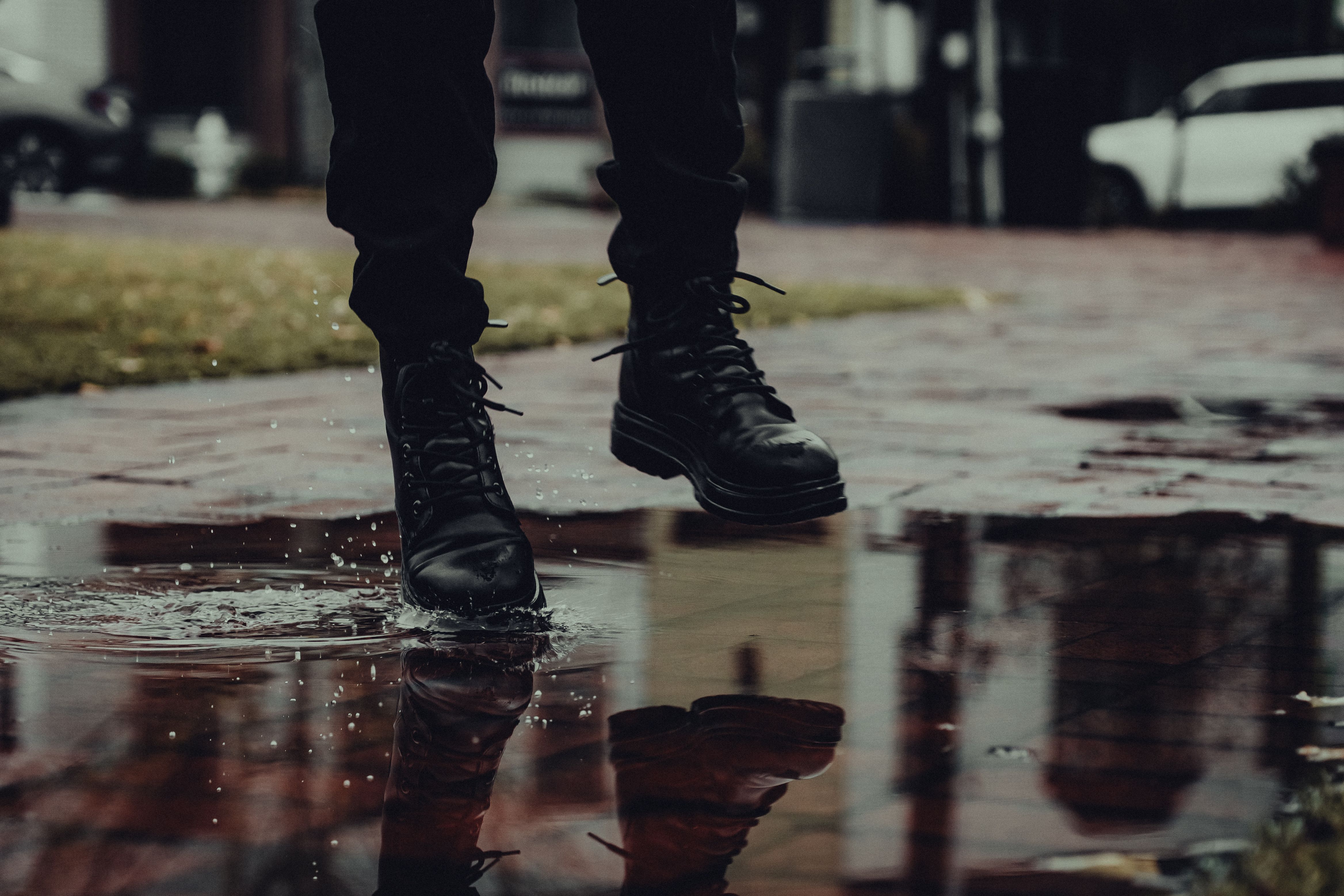 Rainy day boots jumping into a puddle splash · Free Stock Photo