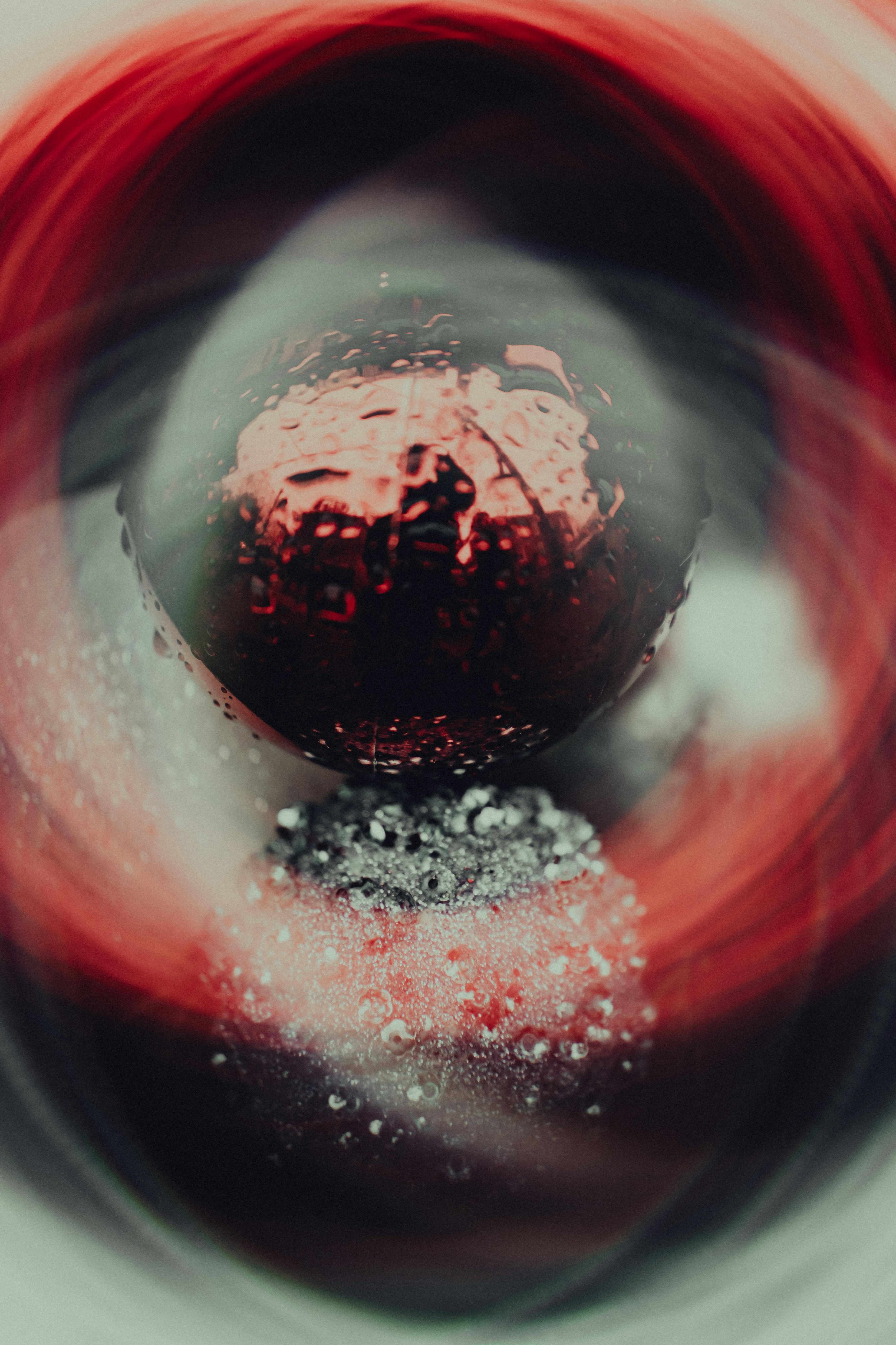Abstract photo with a red and silver swirl design, evoking a sense of motion.