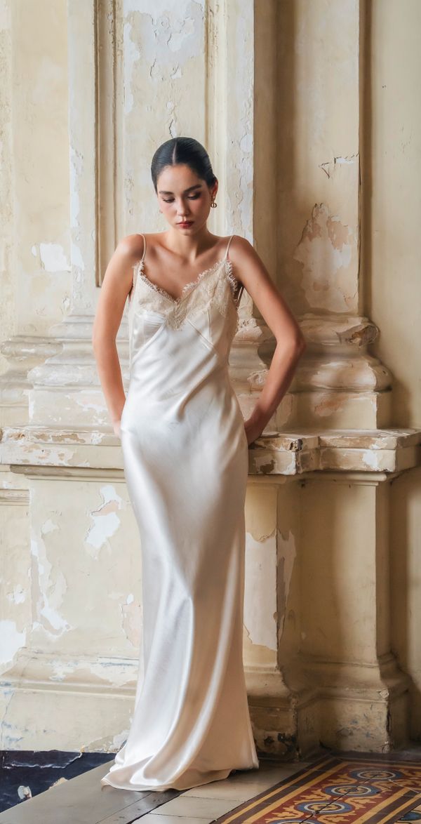 Woman in an ivory cowl-neck satin dress