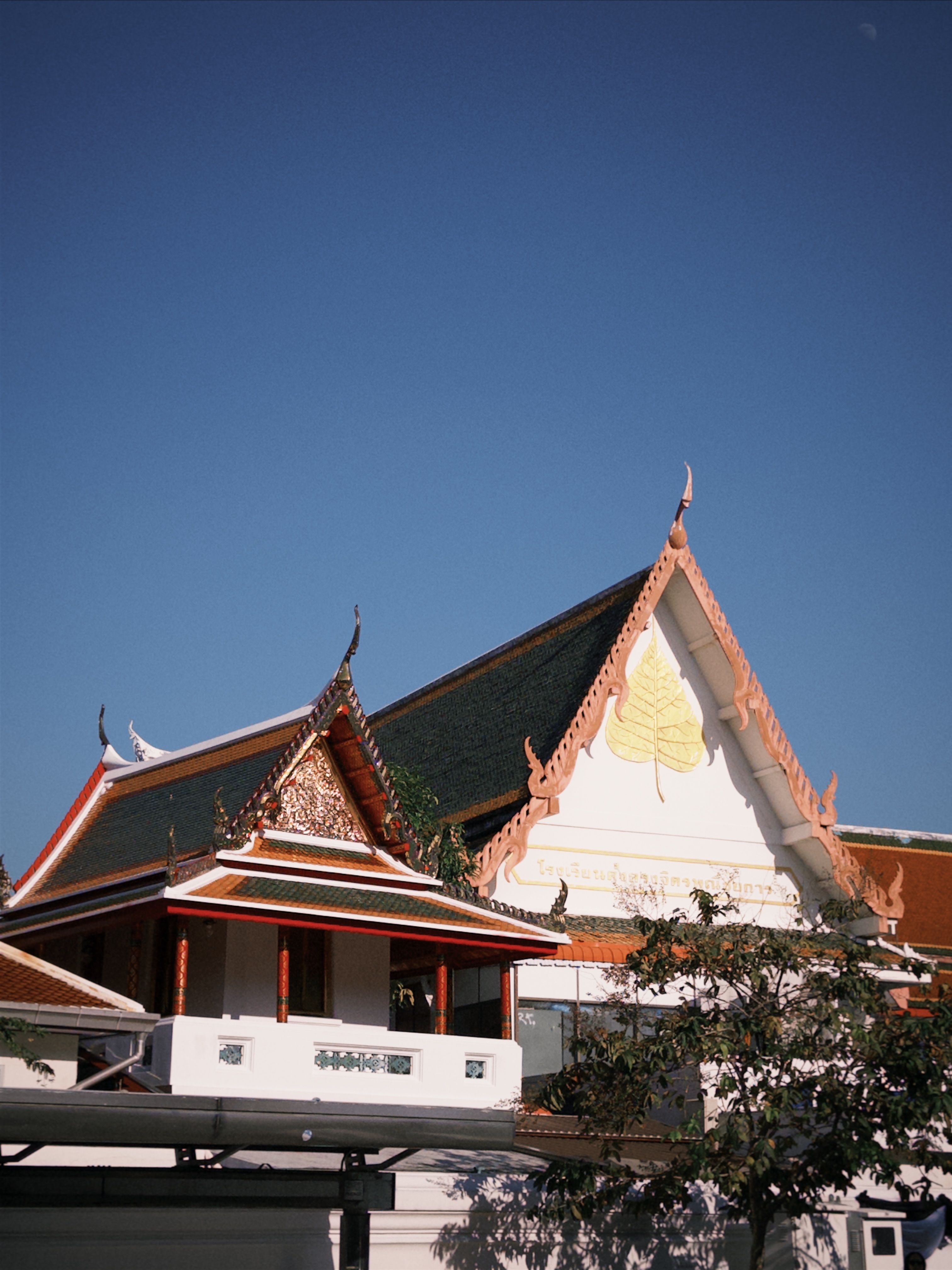 Traditional Thai Temple Architecture under Blue Sky · Free Stock Photo