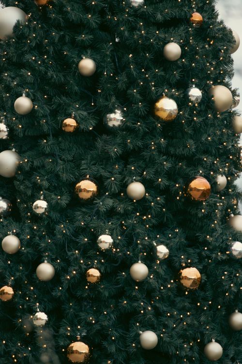 Free Elegant Christmas tree adorned with gold and silver ornaments in Jönköping, Sweden. Stock Photo