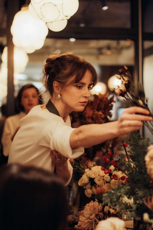 A florist arranging a bouquet of fresh flowers — photo by Anhelina Vasylyk on Pexels