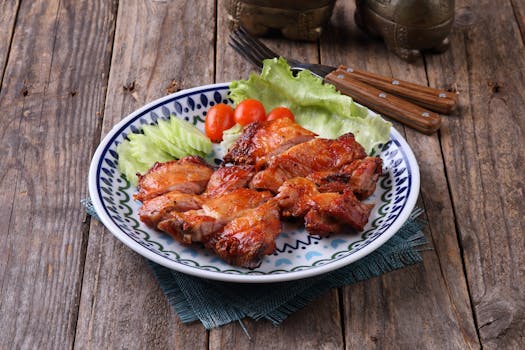 Juicy grilled chicken on a rustic plate with fresh vegetables for a hearty meal.