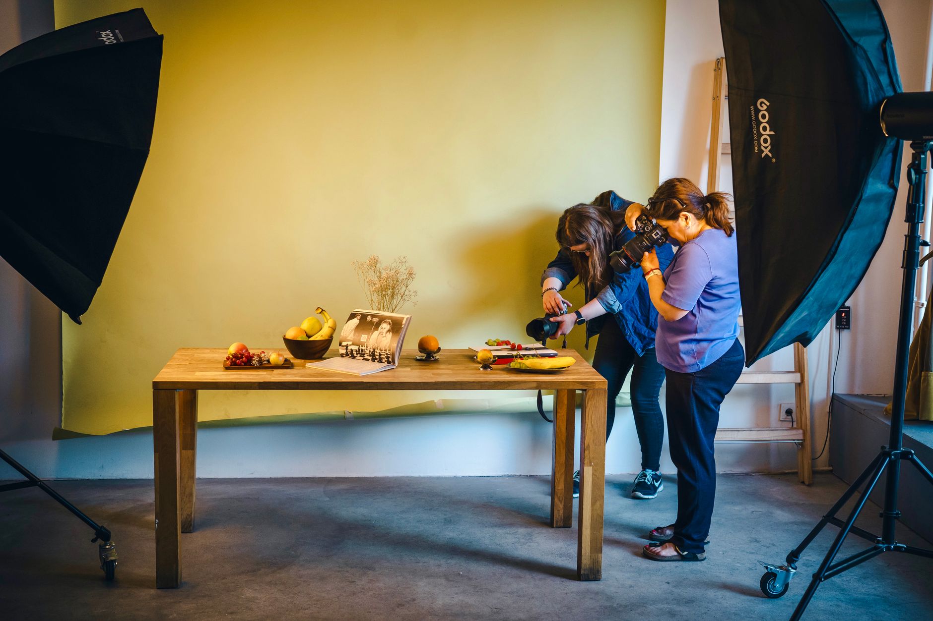 Two photographers working on a food shoot in a Berlin studio with professional lighting.