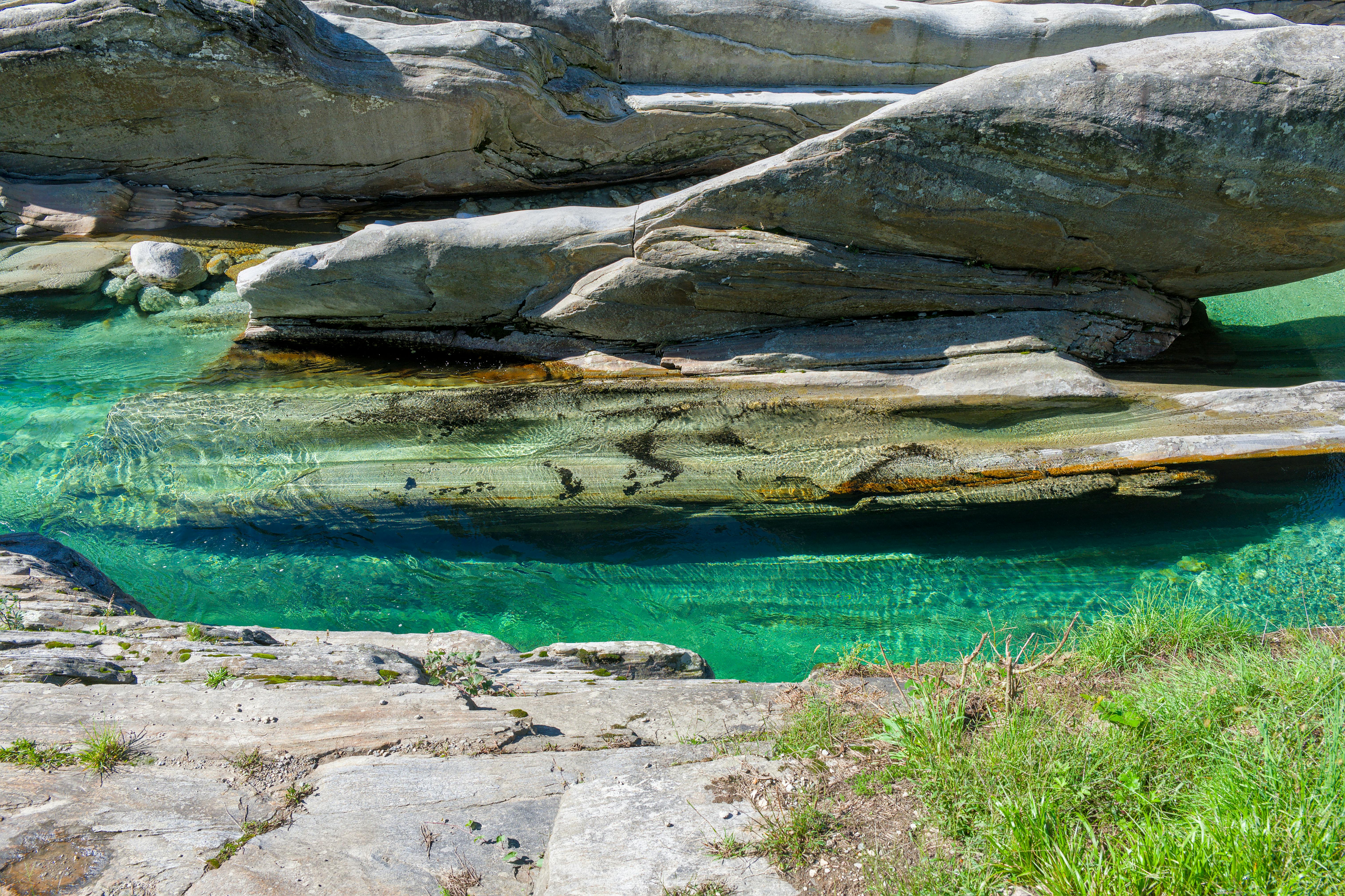 Crystal clear emerald waters and smooth stones in Verzasca Valley, Switzerland.