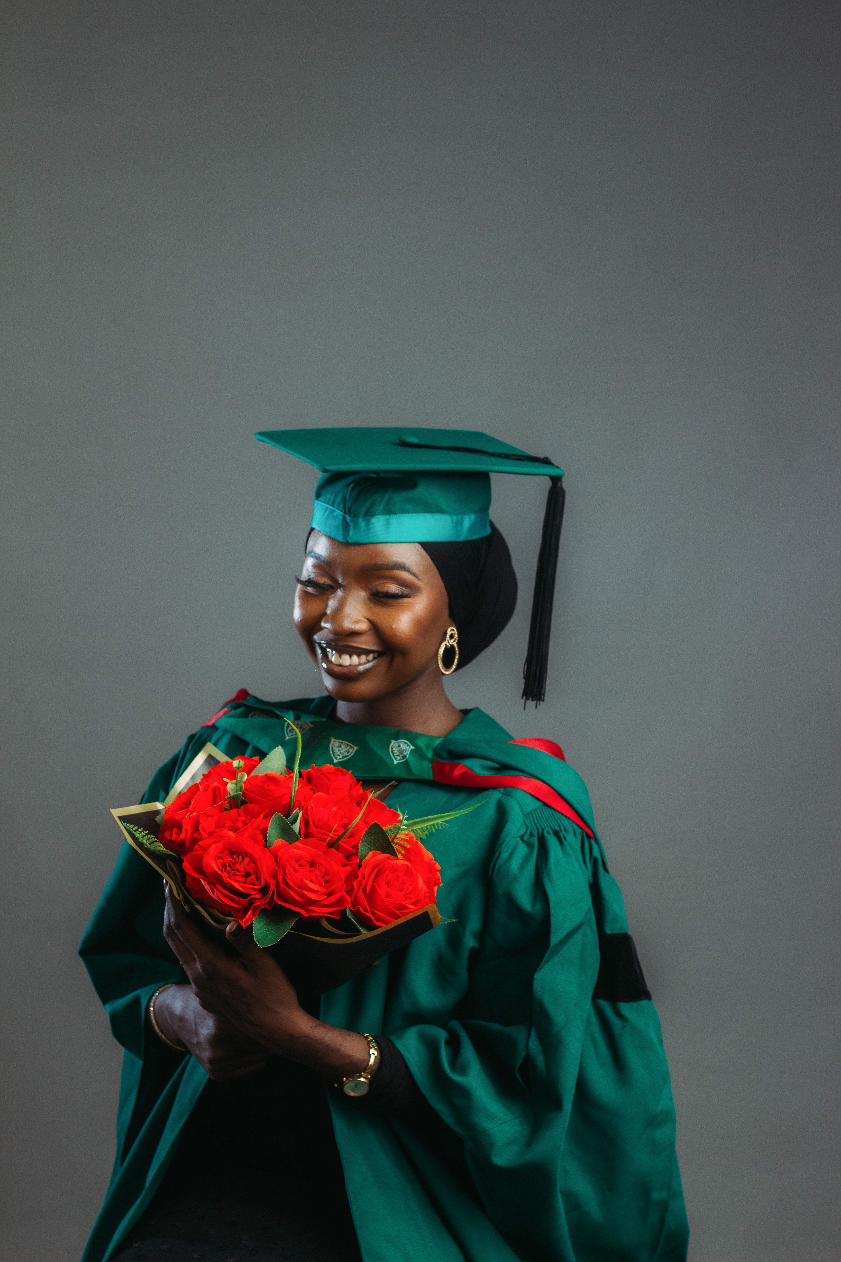 Joyful Graduate Holding Red Roses · Free Stock Photo