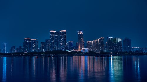 Free Captivating view of Hangzhou's skyline reflecting on Qiantang River at night. Stock Photo
