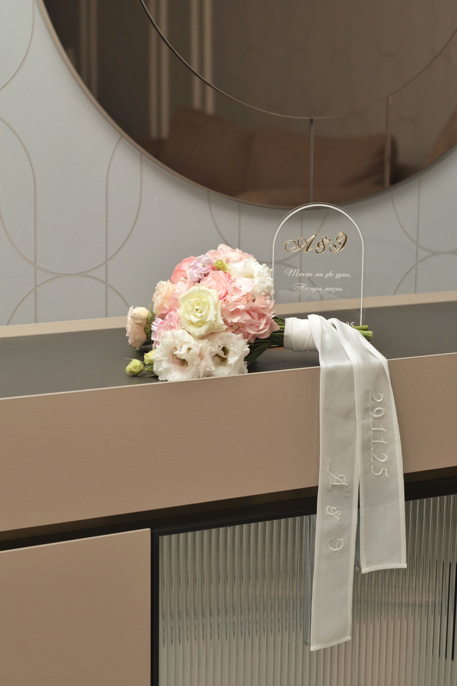 Wedding bouquet with a personalized ribbon on a countertop