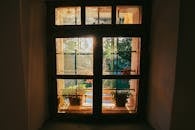 Sunlit Window with Potted Plants in Albanian Village