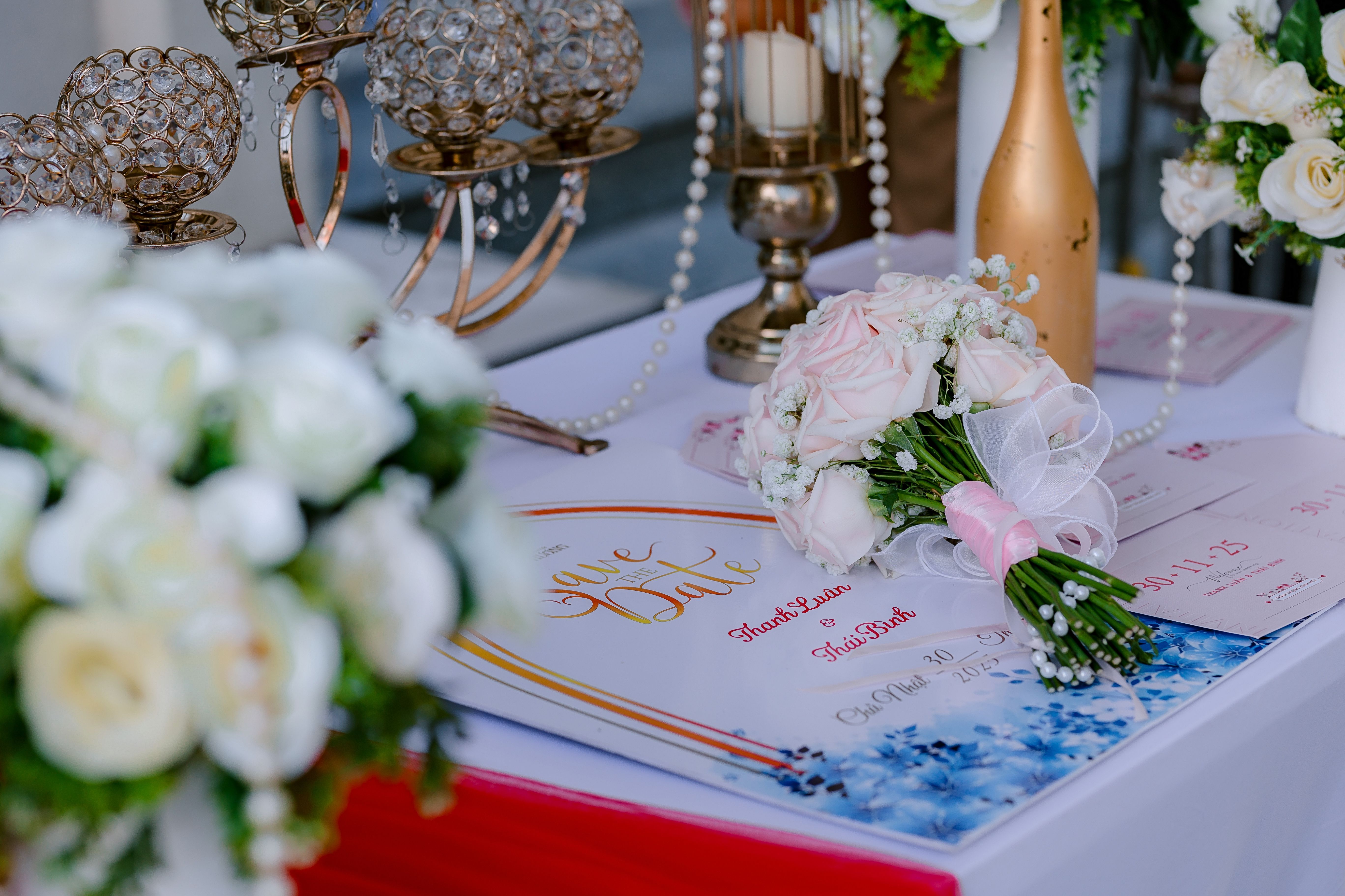 A sophisticated wedding table setup featuring elegant bouquets, candles, and decoration for an upscale event.