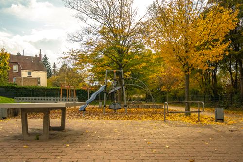 Free Capture of a serene autumn playground with vibrant foliage in Lower Saxony, Germany. Stock Photo