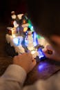 Child Playing with Illuminated Winter Diorama