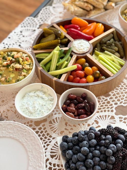 Free Vibrant vegetable platter with dips and berries on a lace table setting, perfect for gatherings. Stock Photo
