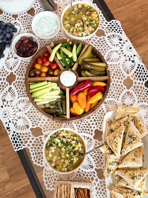 Free Colorful veggie platter with dips on a lace tablecloth, perfect for gatherings. Stock Photo