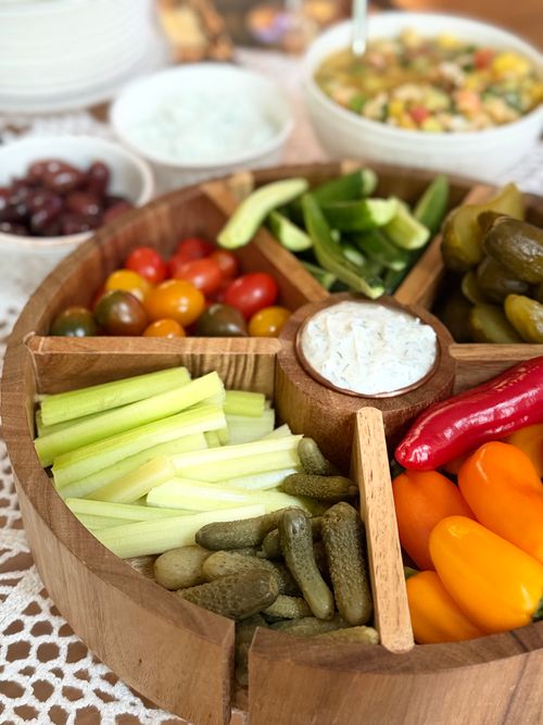 Free Vibrant assortment of fresh vegetables with dips arranged in a wooden platter. Stock Photo