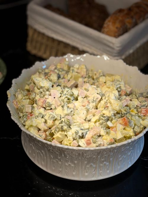 Free Delicious homemade Russian Olivier salad with peas, carrots, and potatoes in a decorative bowl. Stock Photo