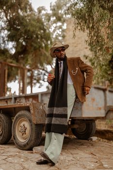 Chic outdoor portrait of a man in trendy attire exuding confidence and style.