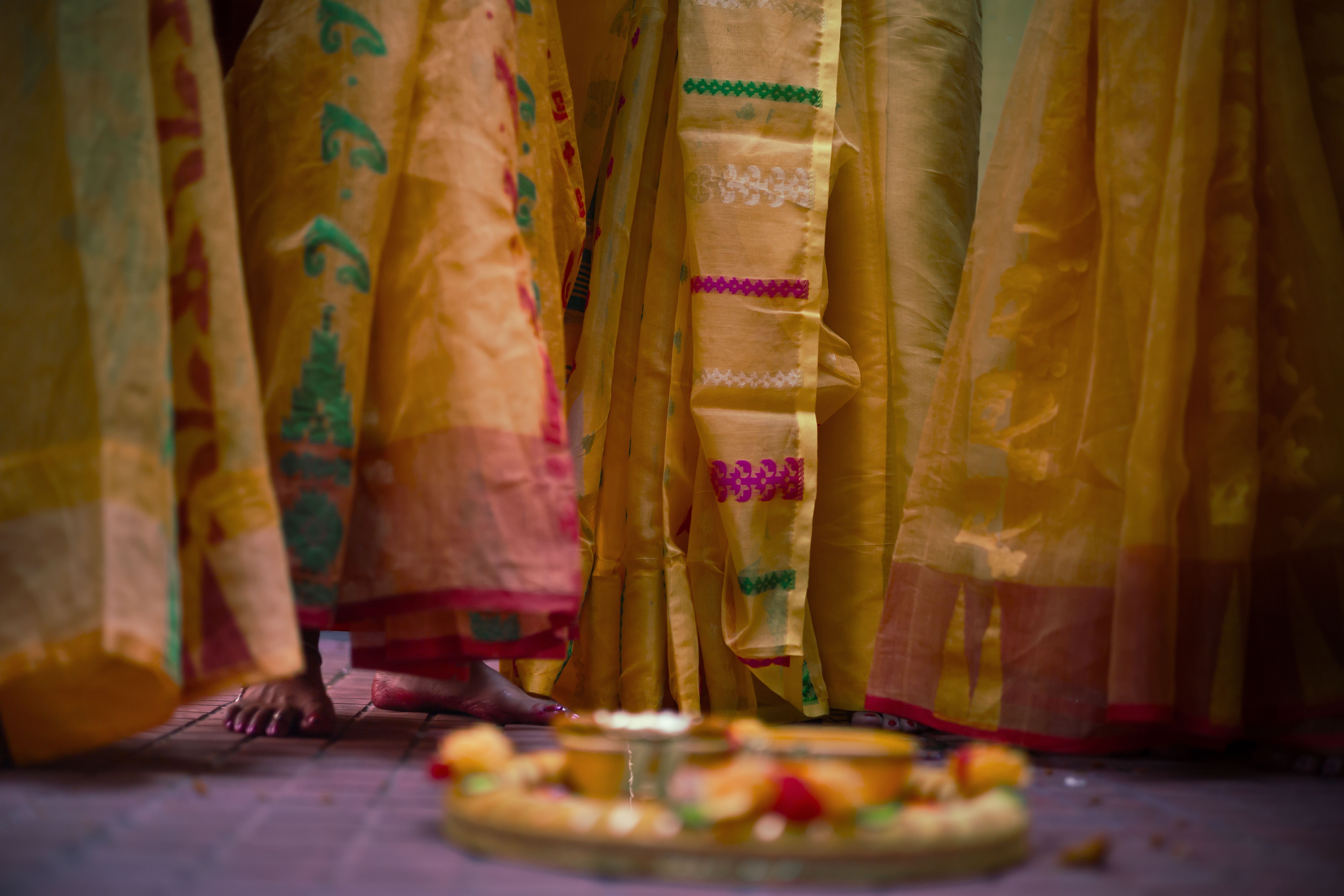 Vivid cultural celebration with women in colourful cotton sarees at an Indian ceremony