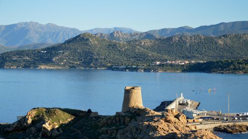 Free Scenic landscape of L'Île-Rousse, Corsica with mountains and coastline. Stock Photo