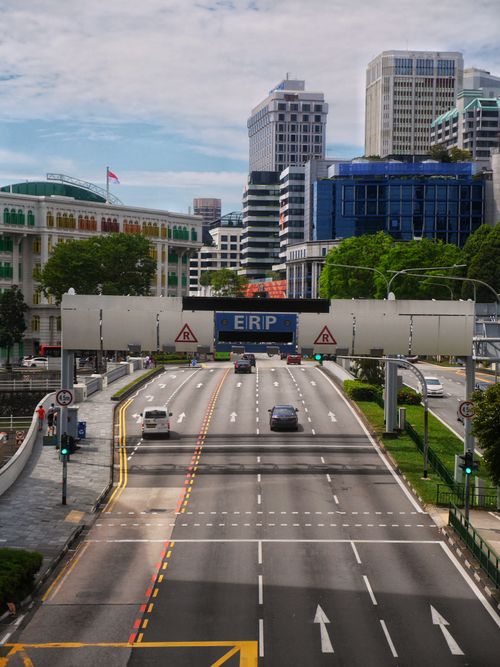 Free Busy roadway with Electronic Road Pricing gantry in downtown Singapore, showcasing urban architecture. Stock Photo