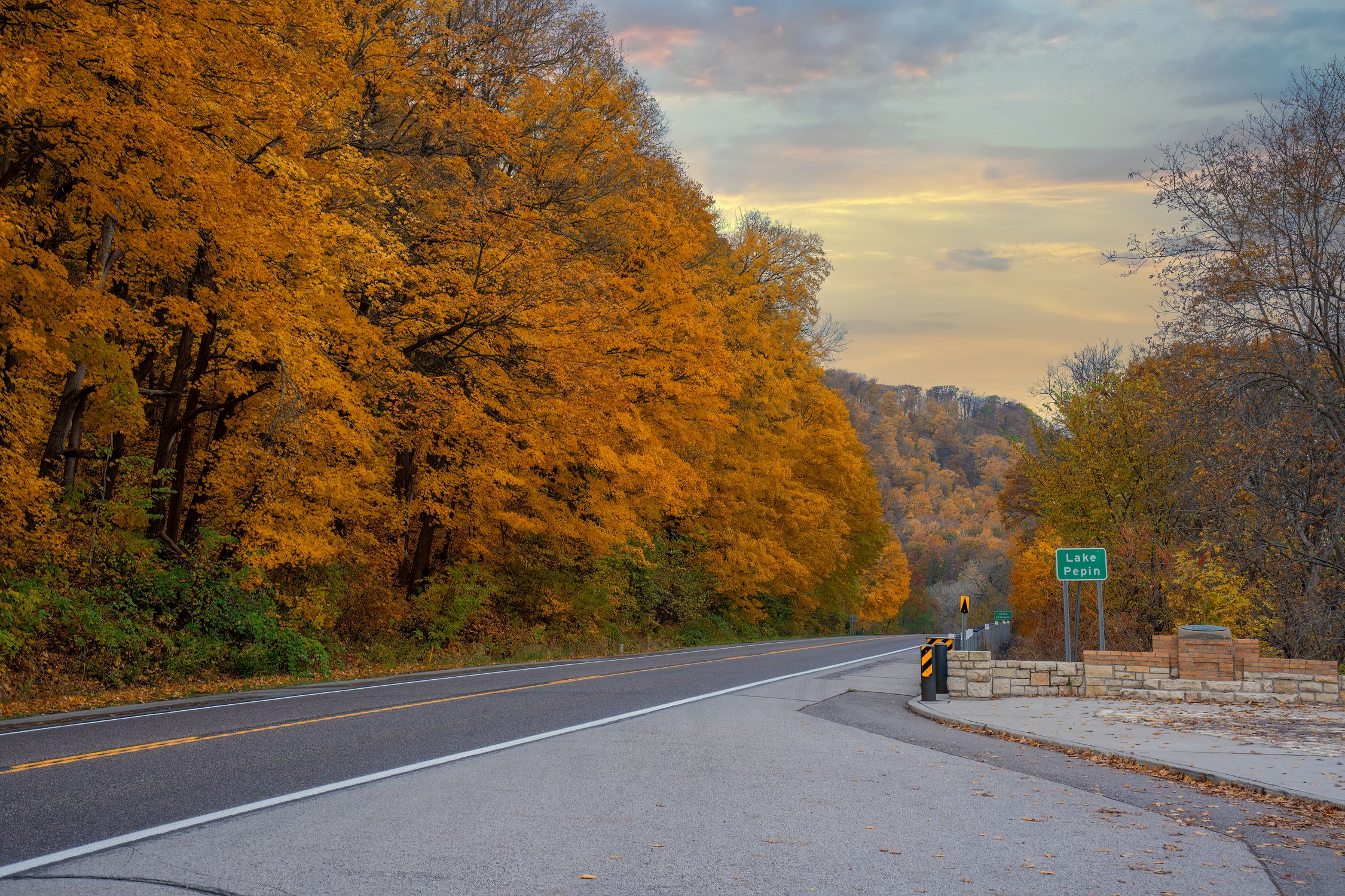 Scenic autumn drive through vibrant fall foliage near Lake Pepin in Reads Landing, Minnesota.