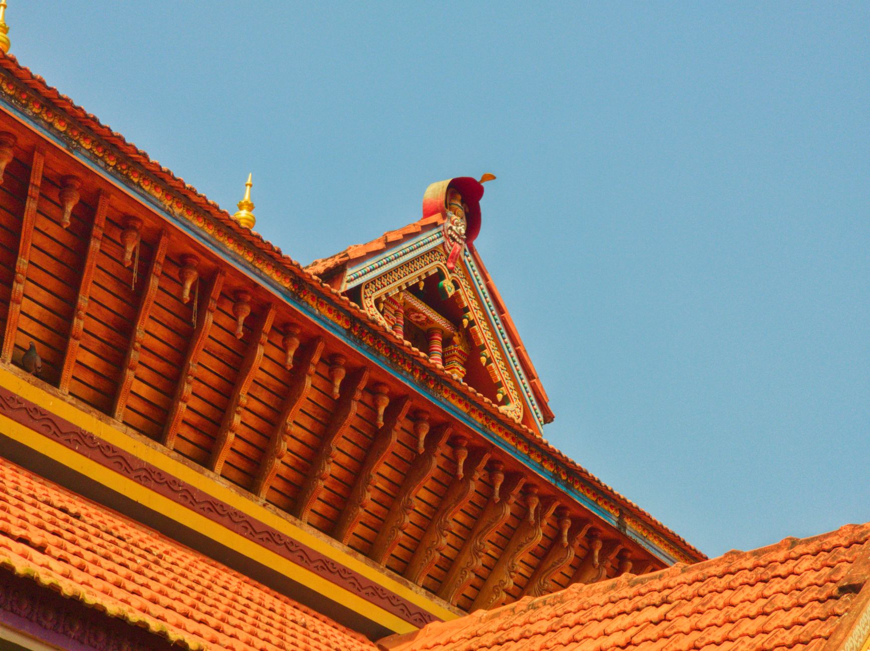 Tiered temple roofwork in the style typical of coastal Karnataka's shrines - the detail that makes these stops worth the detour