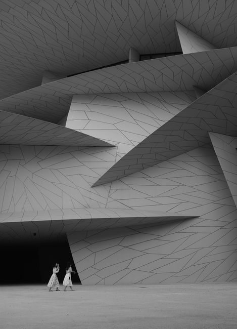 Striking monochrome image of Doha's modern architecture with two figures.