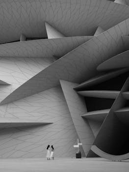 Black and white photo of modern architectural design with human presence in Doha, Qatar.