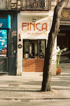 Street view featuring a cafe in Valencia with a bold 'Finca' sign and urban cityscape.