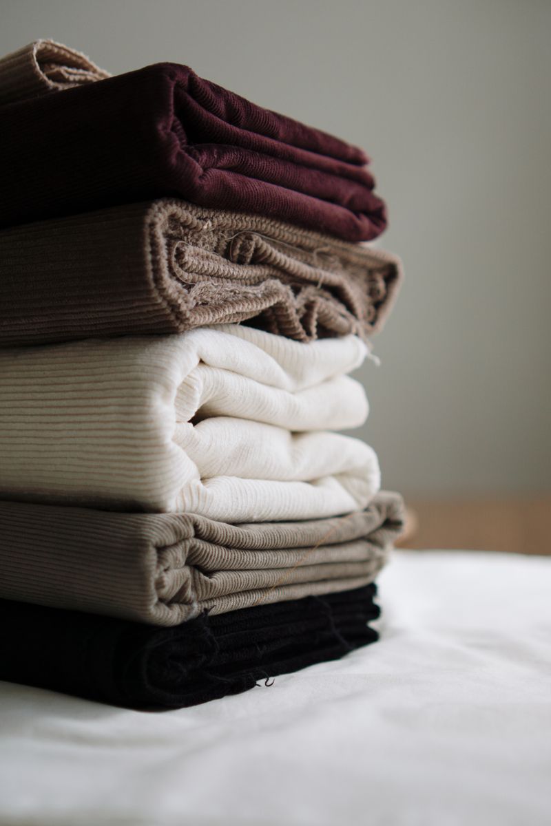 Stack of folded fabrics in neutral tones — Berna on Pexels