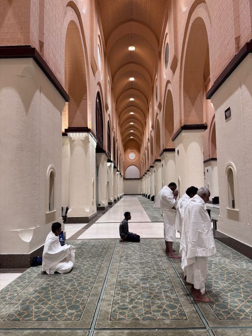 Free Muslim men praying inside a mosque in Madinah, showcasing Islamic architecture. Stock Photo