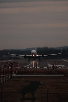 A commercial airplane taking off during twilight on a runway in Windsor Locks, Connecticut.