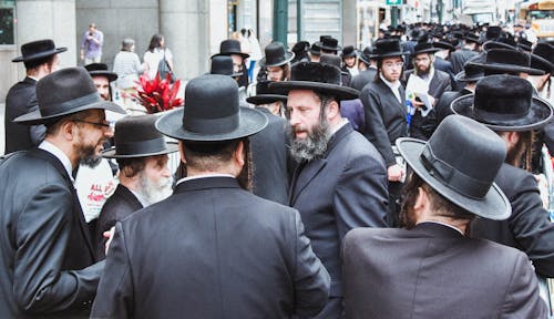 Man in Black Suit Jackets and Black Hats