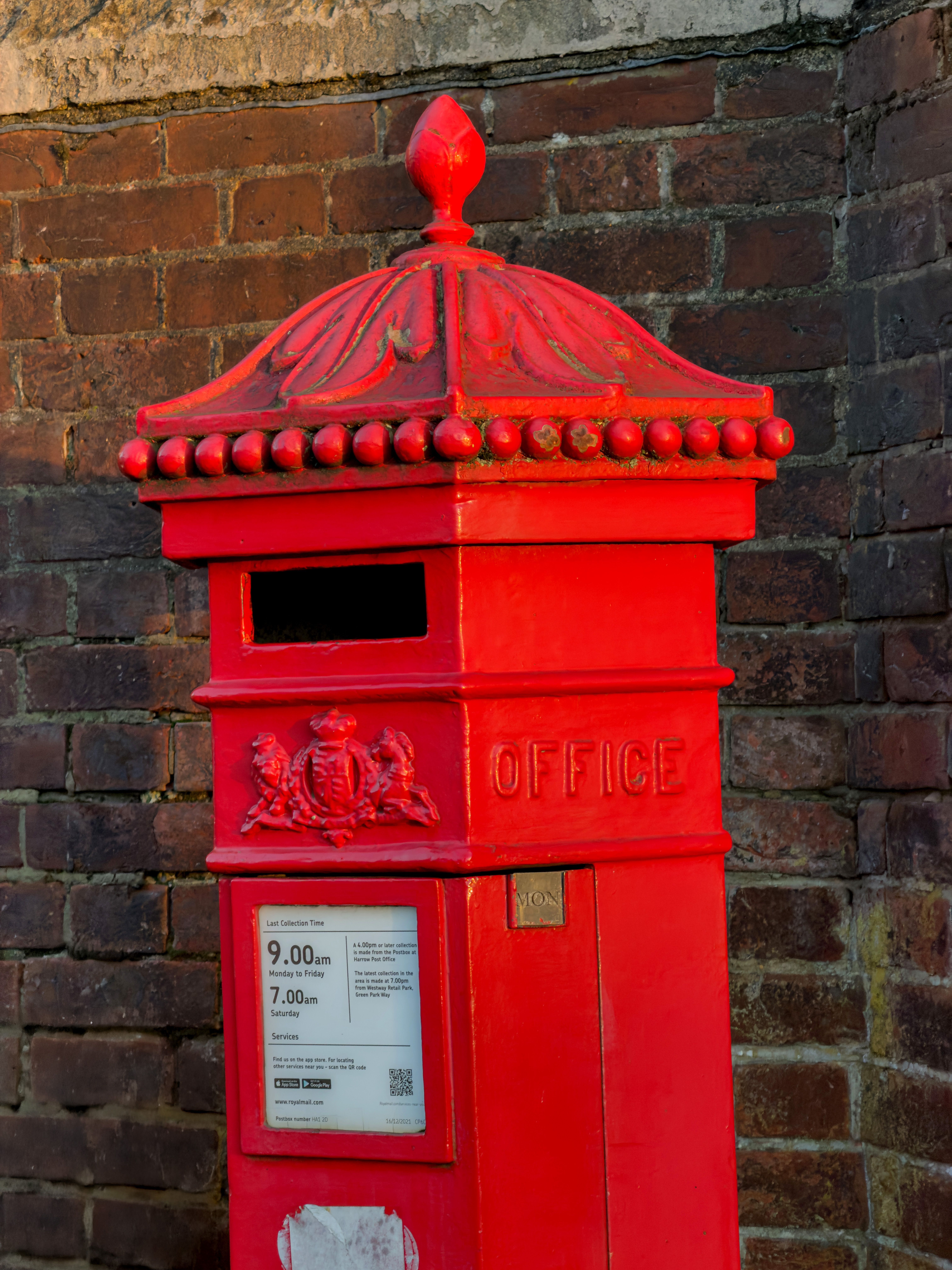 Iconic Red British Post Box on Brick Wall · Free Stock Photo